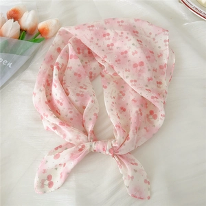 Detail of pink chiffon scarf with red cherry prints and decorative tulip flowers