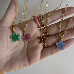 Gold plated titanium necklaces with colorful enamel flower pendants in hand