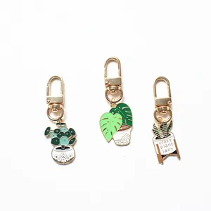 Creative plant keychain set with three metal bonsai charms and golden lobster clasp for bags