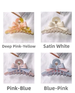 Detail of four colorful acetate bow hair claws with vintage stitching texture