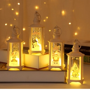 Detailed view of four white LED Christmas lanterns with Santa and snowman patterns
