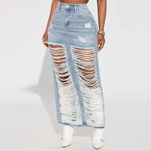 Detail of high waisted light blue denim maxi dress with heavy distressed ripped effects