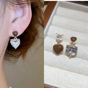 Asymmetric heart drop earrings with brown enamel and clear zircon in gold setting