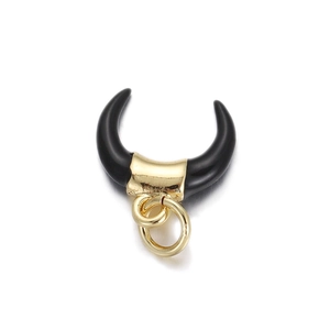 Detailed view of horn shaped black resin pendant with gold plated metal accents