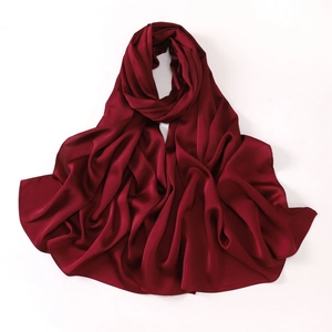Detailed close-up of wine red faux silk chiffon scarf with elegant drapes and texture