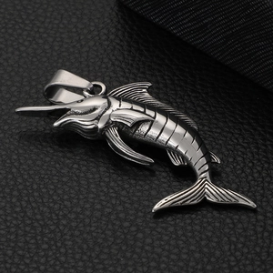 Macro shot of silver stainless steel swordfish pendant showing fine scales and fin details