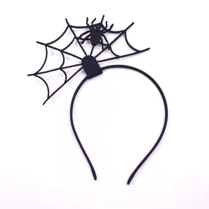 Detailed top view of black Halloween headband with spider and spider web motifs