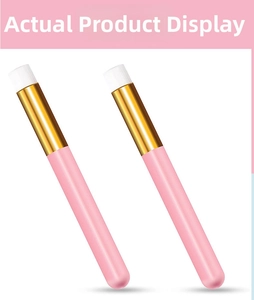 Detail view of two portable nose cleaning brushes with pink handles and soft white bristles
