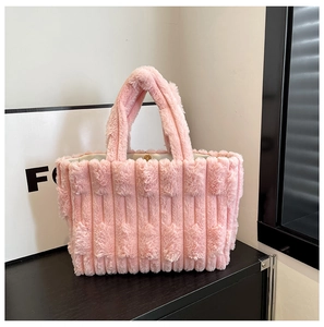 Detailed view of pink plush tote bag showing vertical striped fur texture and wide straps