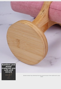 Detail of pink velvet display stand with natural bamboo wood base for jewelry