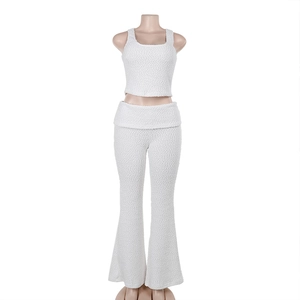 Detail shot of the white textured knit fabric on the sleeveless top and trousers set
