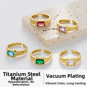 Detail view of five 18k titanium steel rings with colored cubic zirconia gemstones