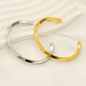 Minimalist Mobius twist C-shaped open bracelets in polished gold and silver finishes