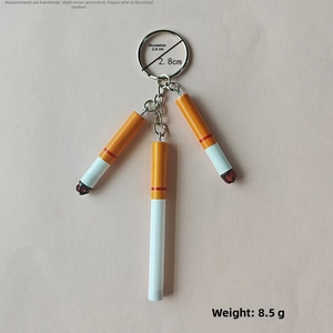 Miniature resin cigarette keychain with silver ring, 2.8cm diameter and 8.5g weight detail