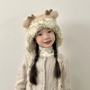 Detail showing soft faux mink fur texture and plush antlers on kids winter earflap hat