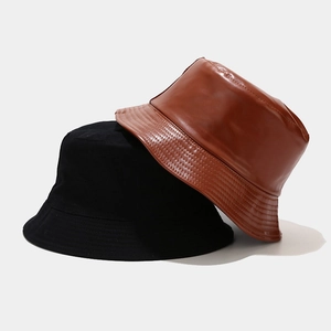 Texture detail of black cotton and brown leather double-sided bucket hats for outdoor wear