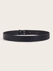 Detail shot of the black leather belt texture and classic silver metal buckle with holes