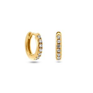 Detailed view of gold huggie earrings with sparkling clear cubic zirconia stones