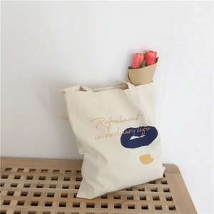Detail of canvas tote bag with artistic color blocks and tulip floral decoration