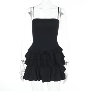 Detail of black strappy bodycon dress featuring multi-layered ruffled hem and slim fit cut