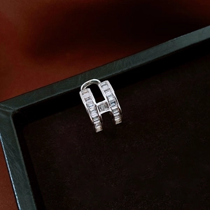 Close-up of H-shaped silver ear cuff set with radiant white rectangular zircon stones
