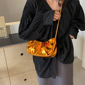 Shiny metallic cloud pleated shoulder bag with slim strap shown as a crossbody