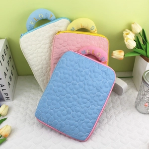 Quilted floral laptop sleeve with Melody embroidery in blue, pink, and beige