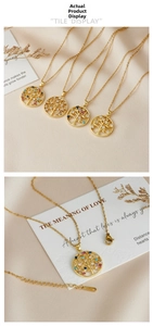 Detail of gold Tree of Life pendant with multicolor gemstones on elegant satin fabric