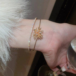 Close-up of a luxury gold-plated double-layer fireworks zircon bracelet on a model wrist