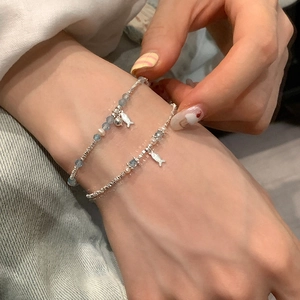 Ethnic silver bead pearl bracelet featuring double layers and small fish pendant on wrist