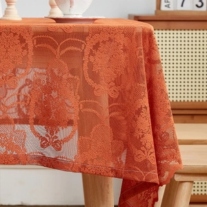 French vintage caramel lace tablecloth with floral hollow design on wooden table