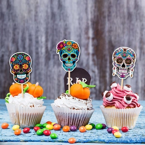 Day of the Dead sugar skull cupcake toppers on blue vintage wood for party decoration