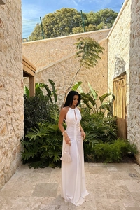 Detail of white halter neck dress featuring front cutout and elegant ruched slim fit texture