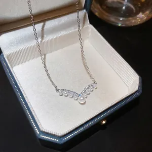 Elegant V-shaped pearl necklace with sparkling zircon pavé in a vintage jewelry box