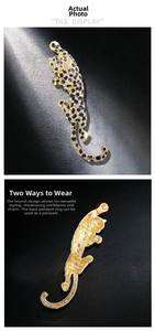 Macro detail of leopard brooch pin with pave-set rhinestones and golden metal finish