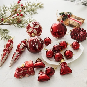 Red and gold Christmas tree ornaments set including train and snowflake shapes