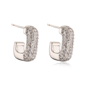 Close-up of silver U-shaped hoop earrings with shimmering pave-set cubic zirconia crystals