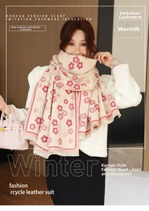 Detailed close-up of cashmere-like scarf with floral prints and elegant fringe edges