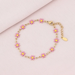 Detail of gold chain bracelet featuring pink enamel daisies and adjustable lobster clasp