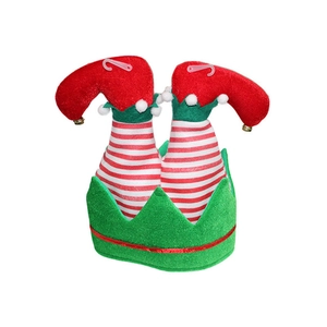 Macro view of Christmas elf hat featuring red and white stripes with gold bell details