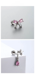 Detail view of silver steel stud earrings featuring pink zircon butterfly and bow pendant
