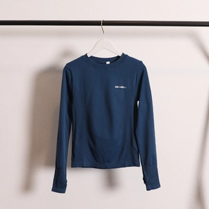 Detail view of quick-dry yoga top featuring thumbholes and breathable side textures