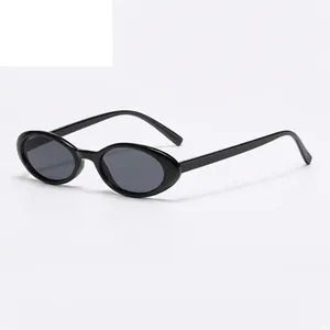 Vintage oval black sunglasses with dark grey lenses and a sleek glossy finish
