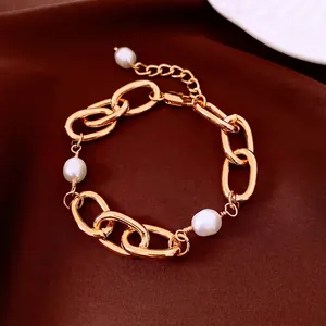 Luxury 18k gold plated chain bracelet with elegant white pearls on velvet backdrop