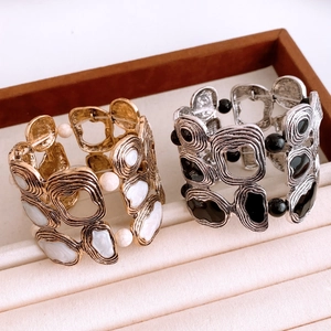 Detail of vintage irregular ripple textured bangles in gold and silver finish