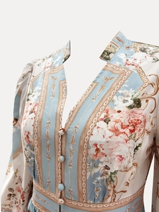 Detailed view of elegant V-neckline with single-breasted buttons and floral print dress