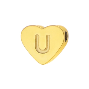 Macro view of gold heart charm with letter U engraving for DIY jewelry making