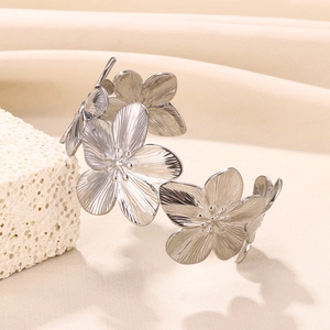 Detail of silver floral cuff bracelet with brushed texture petals and 3D flower centers