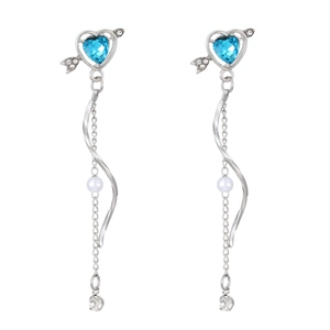 Detail of Cupid's heart earrings with blue crystal, arrow motif, and elegant long chains