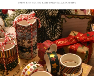 Detailed view of Christmas washi tape with gold foil snowflakes and festive tree patterns